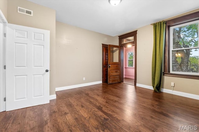 5518 Alaska Ave, Saint Louis, MO 63111 - unfurnished bedroom with multiple windows, wood finished floors, and baseboards