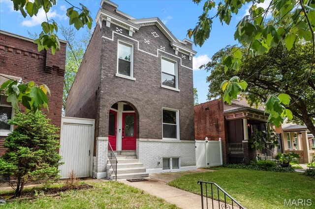 5518 Alaska Ave, Saint Louis, MO 63111 - view of front of home with entry steps, brick siding, and a gate