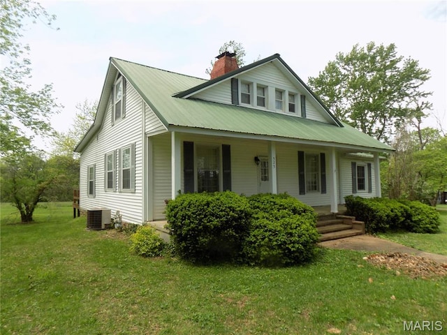 525 Russellville Rd, Arcadia, MO 63621 - view of front of house with central AC unit, covered porch, a chimney, a front yard, and metal roof