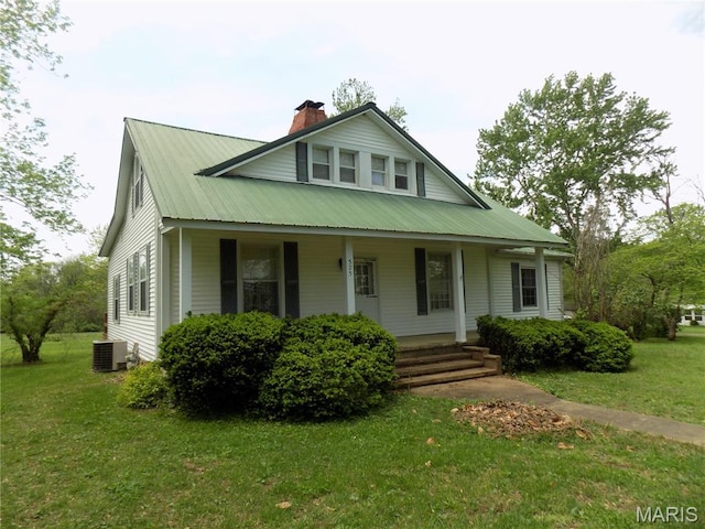 525 Russellville Rd, Arcadia, MO 63621 - view of front facade featuring a front lawn, covered porch, central AC, a chimney, and metal roof