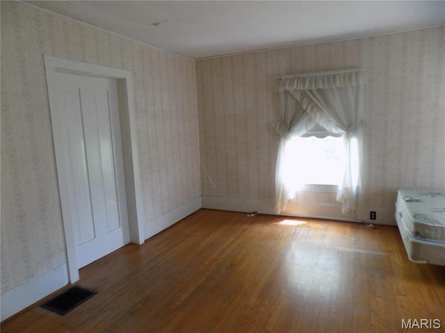 525 Russellville Rd, Arcadia, MO 63621 - empty room featuring wallpapered walls and wood finished floors