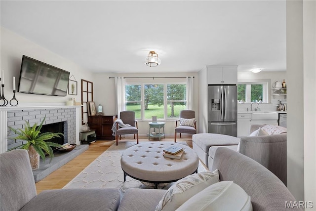3066 W Meyer Rd, Foristell, MO 63348 - living area featuring light wood-style floors and a brick fireplace