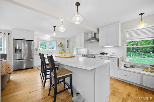 3066 W Meyer Rd, Foristell, MO 63348 - kitchen with stainless steel fridge with ice dispenser, wall chimney exhaust hood, backsplash, and white cabinets