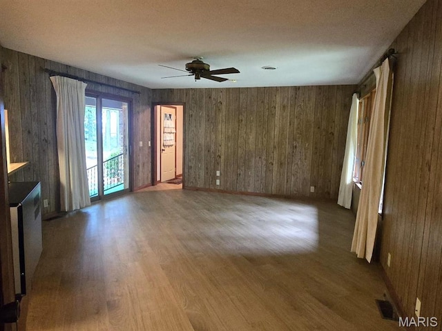 16043 County Road 624, Dexter, MO 63841 - unfurnished living room with ceiling fan, wood finished floors, and wooden walls