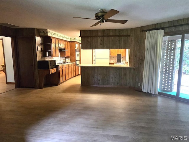 16043 County Road 624, Dexter, MO 63841 - unfurnished living room with wood finished floors, a ceiling fan, wooden walls, and baseboards