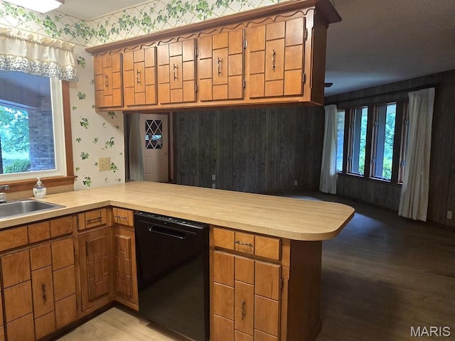 16043 County Road 624, Dexter, MO 63841 - kitchen with black dishwasher, wallpapered walls, a peninsula, light countertops, and a sink