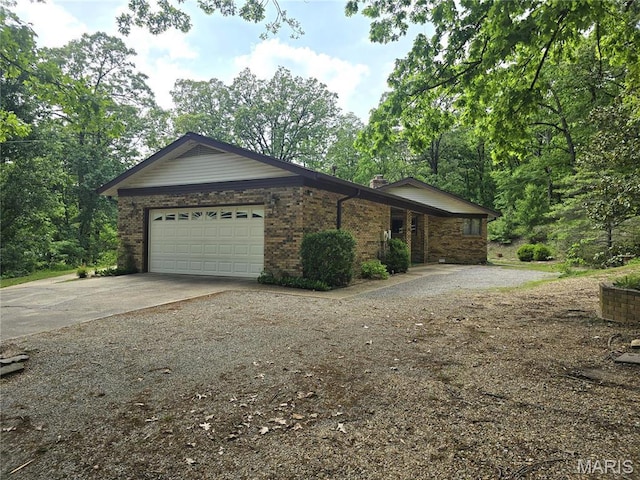 16043 County Road 624, Dexter, MO 63841 - view of front of home with concrete driveway, an attached garage, brick siding, and a chimney