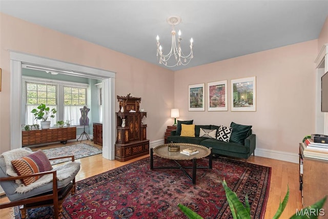 2056 Lafayette Ave Unit 1W, Saint Louis, MO 63104 - living area featuring a chandelier, wood finished floors, and baseboards