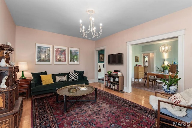 2056 Lafayette Ave Unit 1W, Saint Louis, MO 63104 - living room featuring a chandelier, wood finished floors, and baseboards