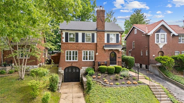 7424 University Dr, University City, MO 63130 - view of front facade featuring a chimney and brick siding