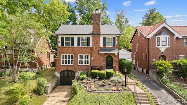 7424 University Dr, University City, MO 63130 - view of front of property featuring a chimney, brick siding, and cooling unit
