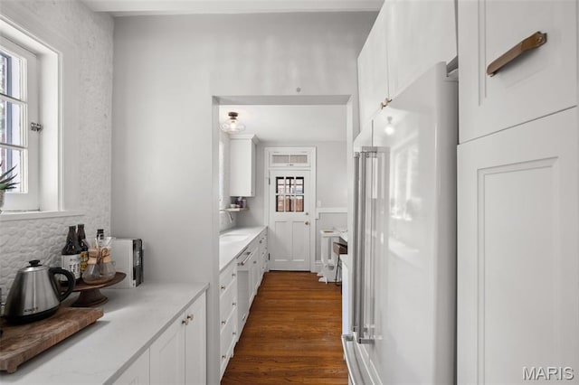 7424 University Dr, University City, MO 63130 - kitchen with high end fridge, healthy amount of natural light, white cabinetry, and light countertops