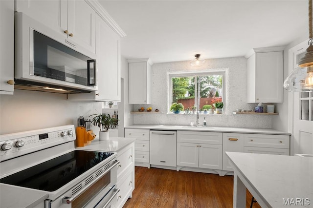 7424 University Dr, University City, MO 63130 - kitchen with white appliances, white cabinetry, dark wood-style floors, and decorative backsplash