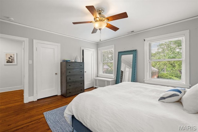 7424 University Dr, University City, MO 63130 - bedroom with wood finished floors, ornamental molding, baseboards, and a ceiling fan