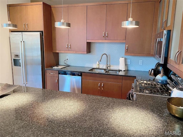 9 N Euclid Ave Unit 510, Saint Louis, MO 63108 - kitchen featuring appliances with stainless steel finishes, a sink, hanging light fixtures, brown cabinetry, and decorative backsplash