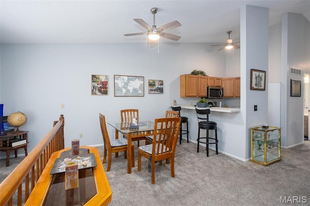 2114 Bayonne Dr Unit 29B, Saint Charles, MO 63303 - dining space featuring ceiling fan, light carpet, high vaulted ceiling, and baseboards