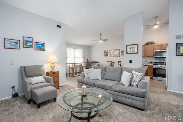 2114 Bayonne Dr Unit 29B, Saint Charles, MO 63303 - living area featuring light colored carpet, ceiling fan, baseboards, and high vaulted ceiling