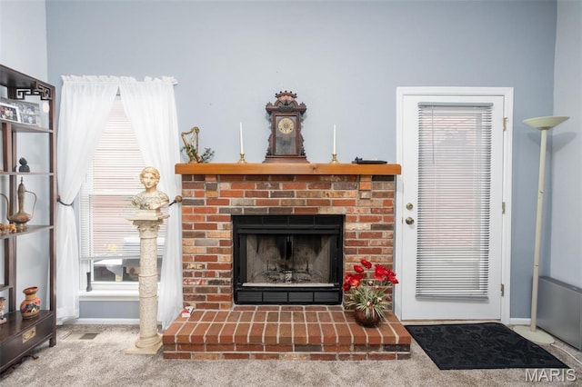 2114 Bayonne Dr Unit 29B, Saint Charles, MO 63303 - living area with a brick fireplace, carpet, and baseboards
