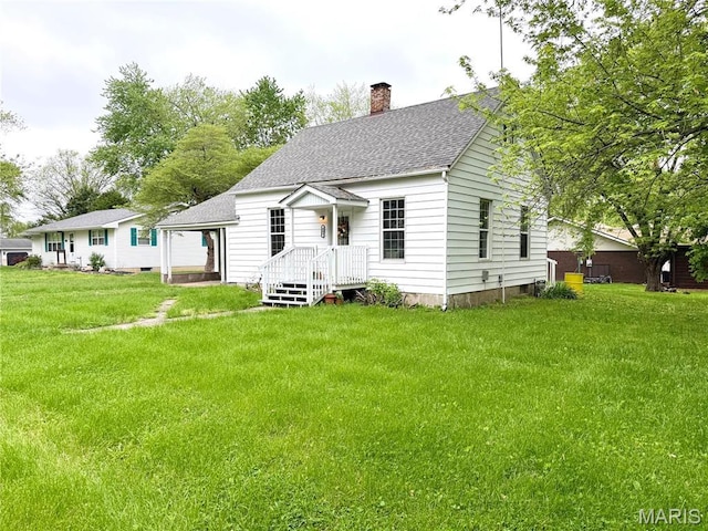 405 W Magnolia St, Marine, IL 62061 - view of front facade with a chimney, roof with shingles, and a front lawn