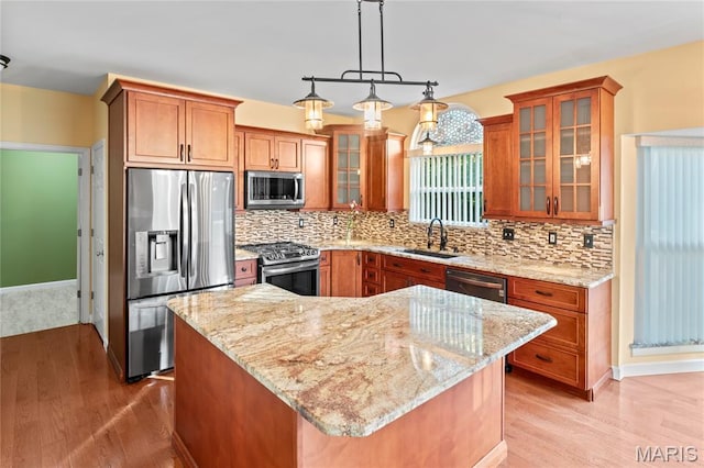 2158 Avalon Ridge Cir, Fenton, MO 63026 - kitchen with stainless steel appliances, a sink, light wood finished floors, and brown cabinets