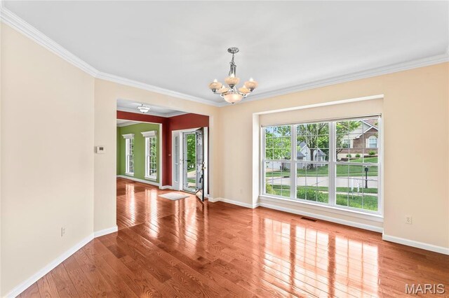 2158 Avalon Ridge Cir, Fenton, MO 63026 - unfurnished room featuring a chandelier, crown molding, wood finished floors, and baseboards
