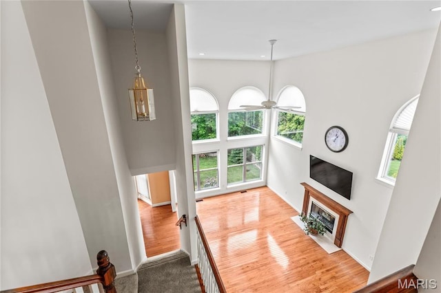 2158 Avalon Ridge Cir, Fenton, MO 63026 - unfurnished living room featuring healthy amount of natural light, a fireplace with flush hearth, ceiling fan, baseboards, and recessed lighting