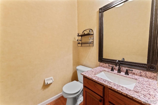 2158 Avalon Ridge Cir, Fenton, MO 63026 - half bathroom featuring toilet, vanity, baseboards, and wood finished floors