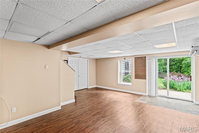 2158 Avalon Ridge Cir, Fenton, MO 63026 - below grade area with a drop ceiling, wood finished floors, and baseboards