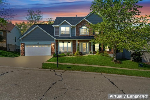 2158 Avalon Ridge Cir, Fenton, MO 63026 - traditional home featuring a garage, brick siding, driveway, and a front lawn