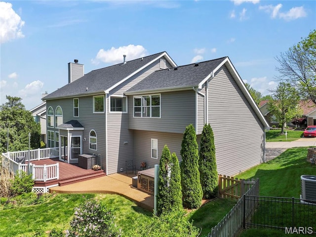 2158 Avalon Ridge Cir, Fenton, MO 63026 - back of property with cooling unit, a deck, a chimney, and a shingled roof