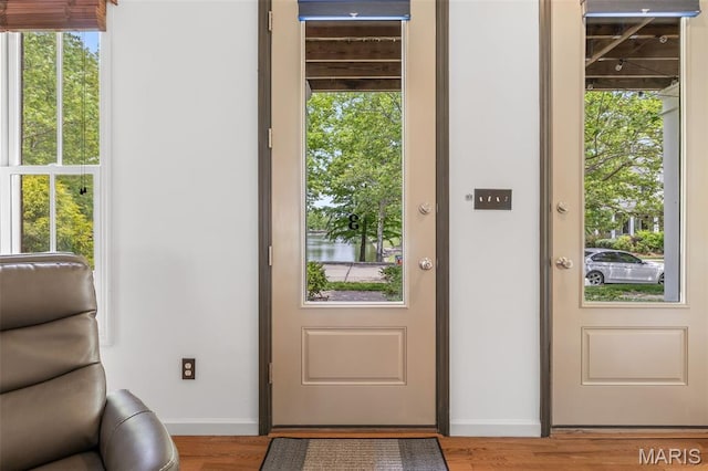 3677 Arpent St Unit 3, Saint Charles, MO 63301 - doorway to outside featuring baseboards and wood finished floors