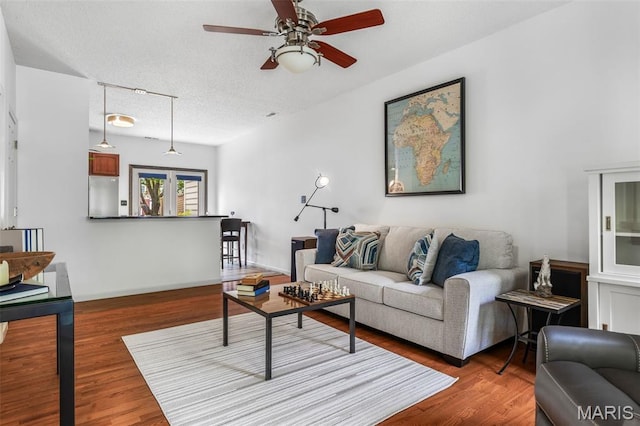 3677 Arpent St Unit 3, Saint Charles, MO 63301 - living room with ceiling fan, wood finished floors, a textured ceiling, and baseboards