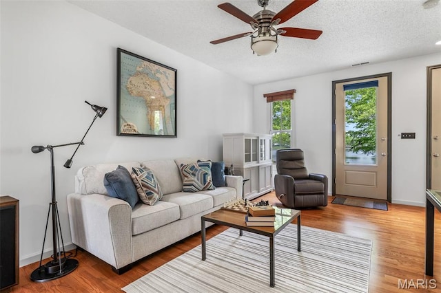 3677 Arpent St Unit 3, Saint Charles, MO 63301 - living room featuring wood finished floors, a ceiling fan, and a textured ceiling