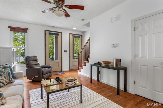 3677 Arpent St Unit 3, Saint Charles, MO 63301 - living room featuring stairs, a textured ceiling, a ceiling fan, and wood finished floors