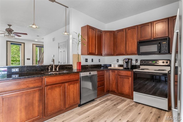 3677 Arpent St Unit 3, Saint Charles, MO 63301 - kitchen with appliances with stainless steel finishes, a sink, dark stone countertops, light wood-style floors, and a ceiling fan