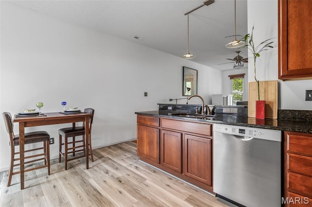 3677 Arpent St Unit 3, Saint Charles, MO 63301 - kitchen with stainless steel dishwasher, a sink, ceiling fan, light wood finished floors, and dark stone countertops