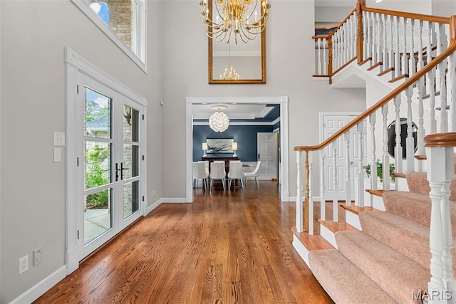 1424 Haarman Oak Dr, Wildwood, MO 63005 - entrance foyer featuring a towering ceiling, a chandelier, stairway, baseboards, and wood finished floors