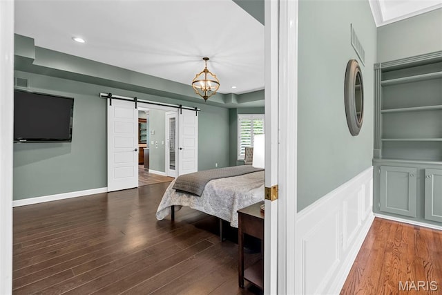 1424 Haarman Oak Dr, Wildwood, MO 63005 - bedroom with a barn door, wood finished floors, recessed lighting, and a chandelier