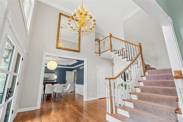 1424 Haarman Oak Dr, Wildwood, MO 63005 - entryway with a chandelier, stairway, a towering ceiling, wood finished floors, and ornamental molding