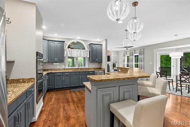 1424 Haarman Oak Dr, Wildwood, MO 63005 - kitchen featuring gray cabinetry, a chandelier, a kitchen island, dark wood-style floors, and recessed lighting
