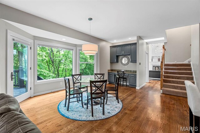 1424 Haarman Oak Dr, Wildwood, MO 63005 - dining space featuring stairway, baseboards, dark wood finished floors, and recessed lighting