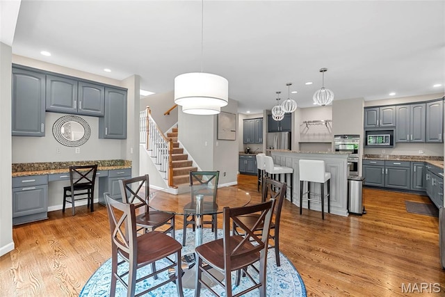 1424 Haarman Oak Dr, Wildwood, MO 63005 - dining area with recessed lighting, light wood-style floors, stairway, and baseboards