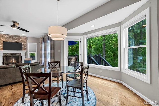 1424 Haarman Oak Dr, Wildwood, MO 63005 - dining space featuring healthy amount of natural light, baseboards, a fireplace, and ceiling fan
