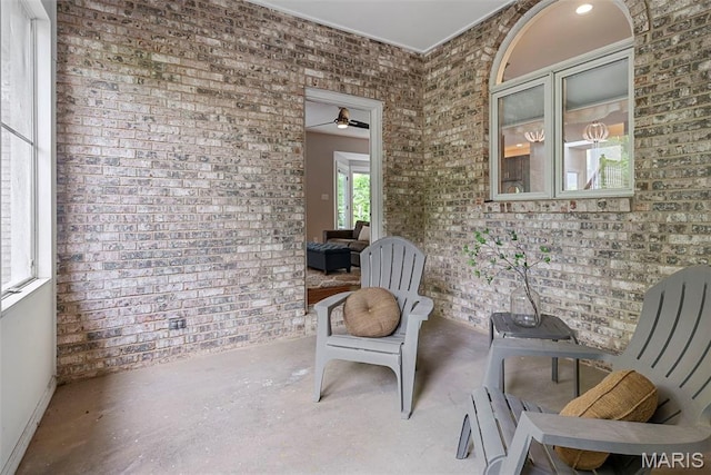 1424 Haarman Oak Dr, Wildwood, MO 63005 - living area with brick wall, unfinished concrete floors, and ceiling fan