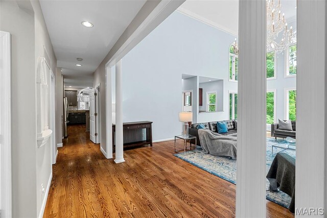 1424 Haarman Oak Dr, Wildwood, MO 63005 - hallway with wood finished floors, recessed lighting, baseboards, a towering ceiling, and a chandelier