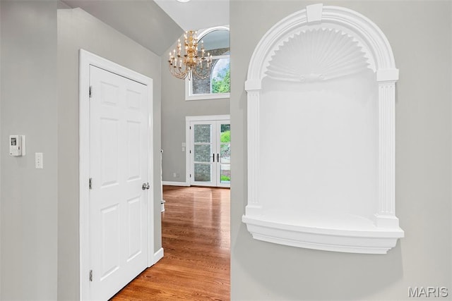 1424 Haarman Oak Dr, Wildwood, MO 63005 - foyer featuring wood finished floors, a chandelier, baseboards, and vaulted ceiling