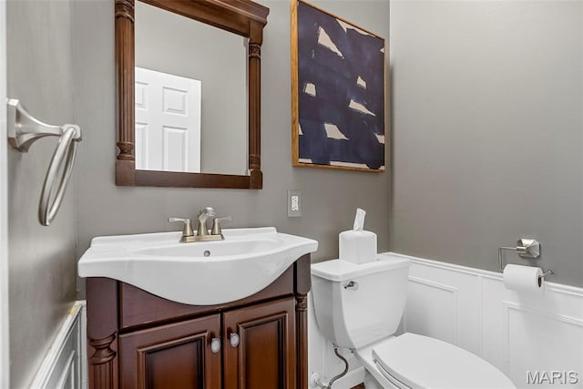 1424 Haarman Oak Dr, Wildwood, MO 63005 - bathroom with a decorative wall, wainscoting, vanity, and toilet