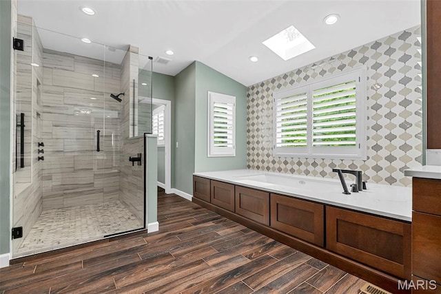 1424 Haarman Oak Dr, Wildwood, MO 63005 - full bathroom featuring a skylight, baseboards, wood finished floors, a shower stall, and a bath