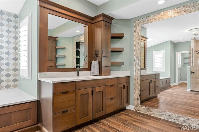 1424 Haarman Oak Dr, Wildwood, MO 63005 - full bath featuring wood finished floors, a tile shower, baseboards, two vanities, and recessed lighting
