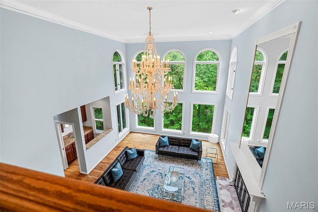 1424 Haarman Oak Dr, Wildwood, MO 63005 - living room featuring a chandelier, a high ceiling, wood finished floors, crown molding, and recessed lighting